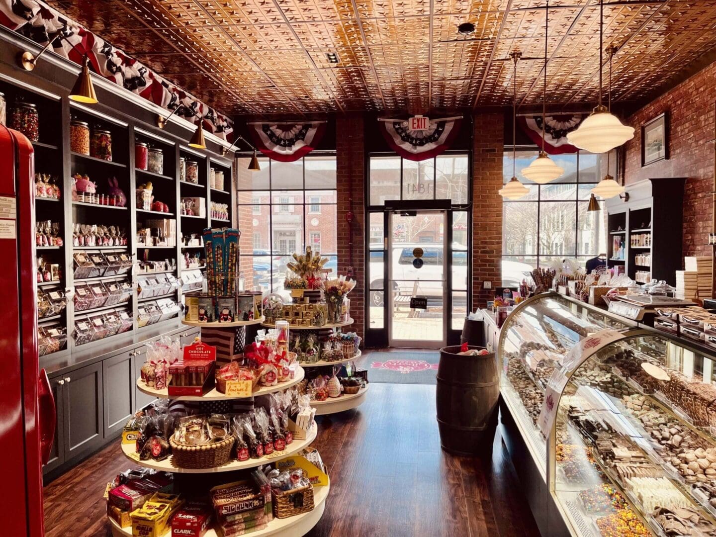 Cozy bakery with wooden shelves and glass display cases filled with treats.